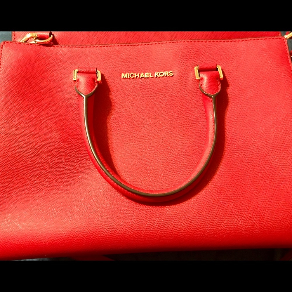 Red Michael Kors bag with removable strap